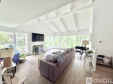 A living room with a grey couch and a fireplace.