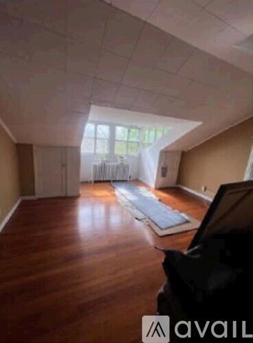 A room with wooden floors and a large window.