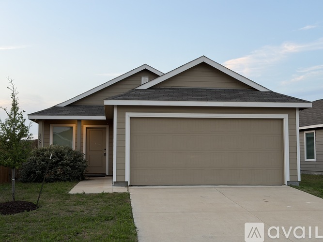 A house with a garage door is available for purchase.