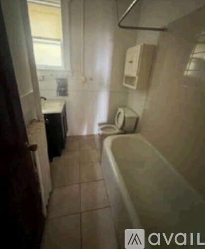 A bathroom with a toilet, sink, and bathtub.