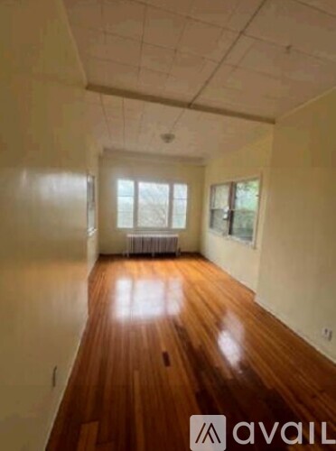 A room with wooden floors and white walls.