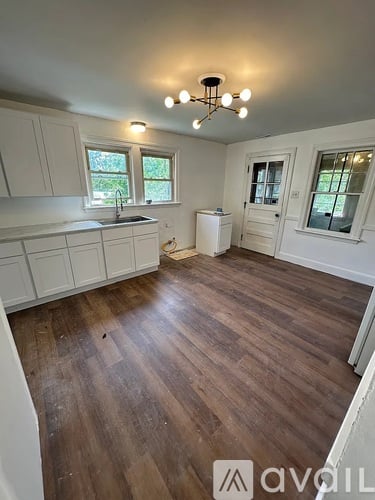 A room with wooden floors and white walls.