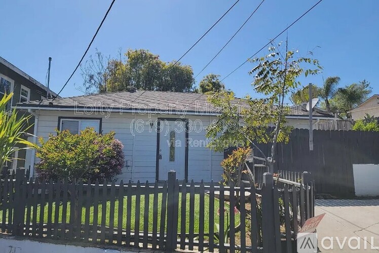 A house with a fence in front of it is for sale.