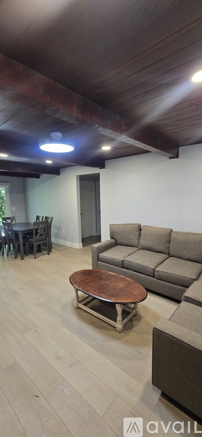 A living room with a brown couch and a wooden coffee table.