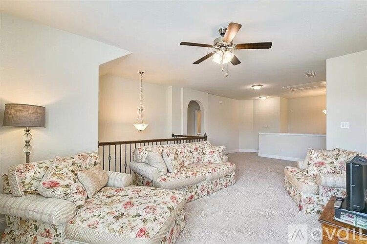 A living room with a sofa set and a television.