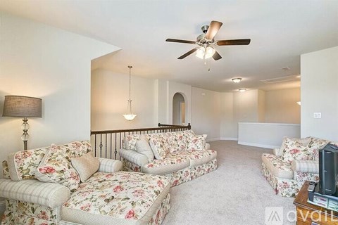 A living room with a sofa set and a television.