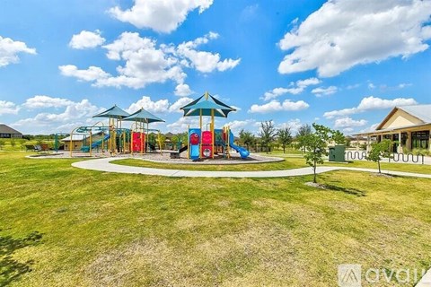 A playground with a blue sky and white clouds in the background.