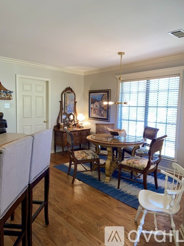 A dining room with a wooden table and chairs.
