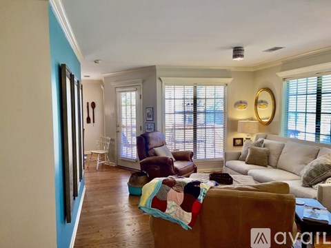 A living room with a brown couch and a white couch.