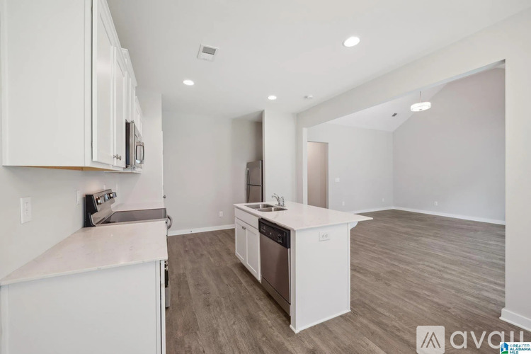 A kitchen with white cabinets and a white countertop.