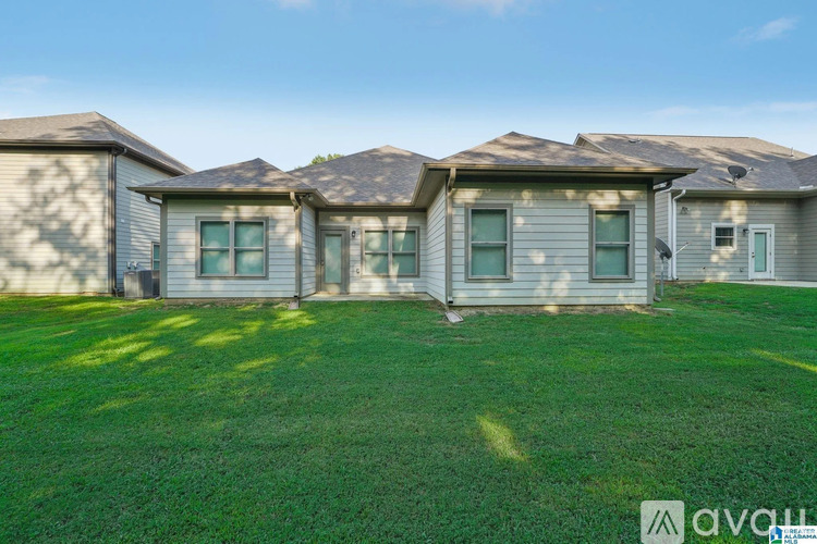 A row of houses with a grassy front yard.