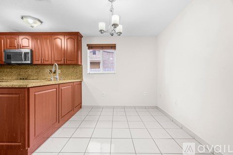 A kitchen with brown cabinets and a granite countertop.