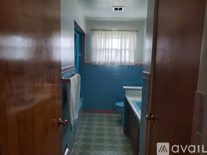 A bathroom with blue walls and a green floor.