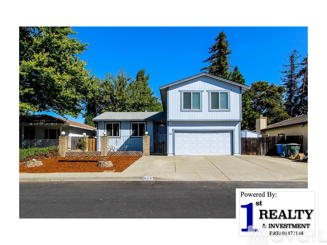 A blue house with a white garage door is shown in the image.