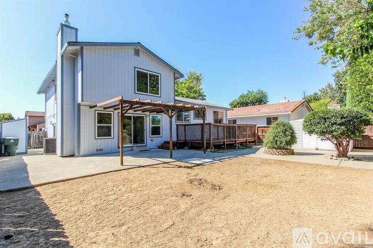 A house with a white exterior and a covered patio area.