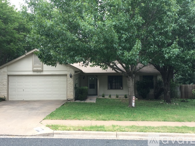 A house with a tree in front of it.