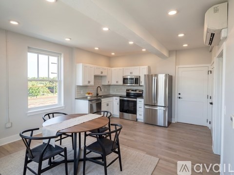 A modern kitchen with a dining table and chairs.