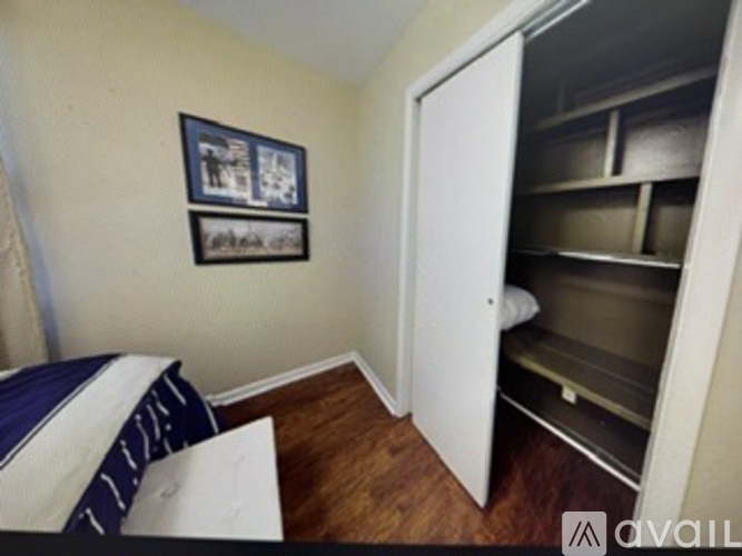 A bedroom with a bed and a small pantry.