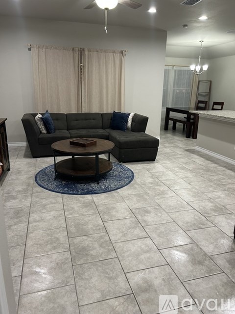 A living room with a grey couch and a coffee table.