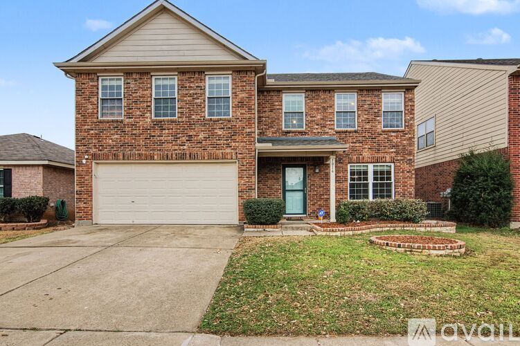 A brick house with a garage door and a front door.