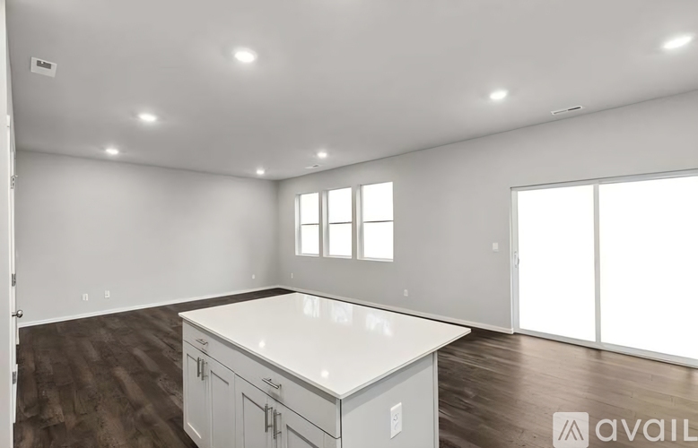 A spacious room with a large island in the middle.