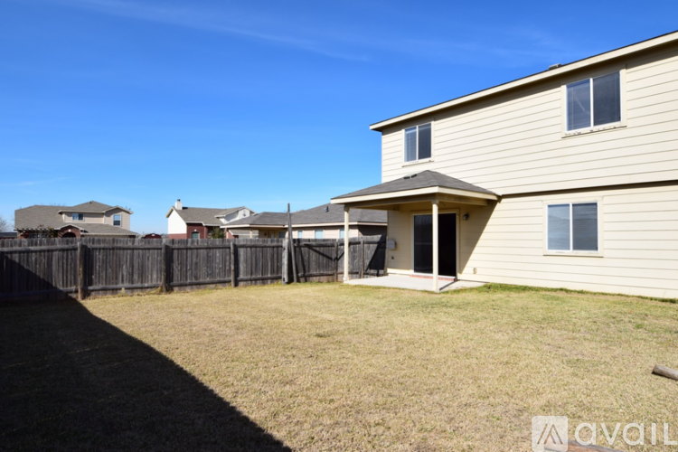 A house with a fence and a grassy yard is for sale.