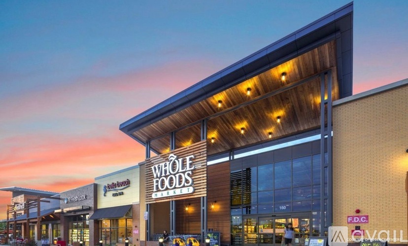 A Whole Foods store is shown with a sunset in the background.