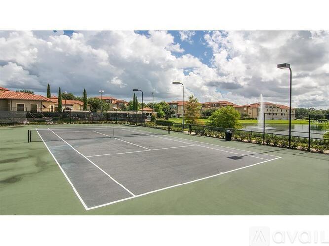 A tennis court with a net and a sign that says "AVAILABLE".