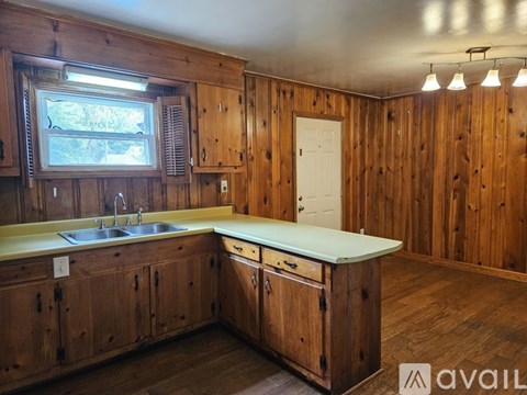 A kitchen with wooden cabinets and a white countertop.