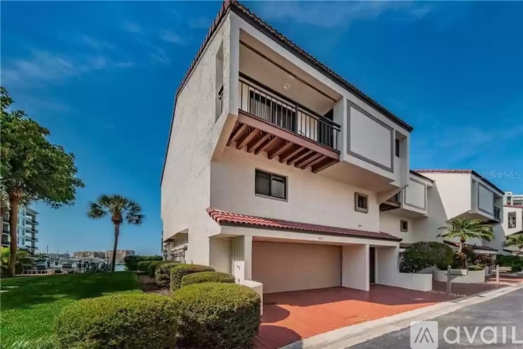 A modern two-story house with a balcony on the second floor.