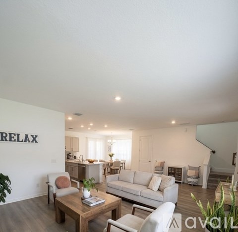 A living room with a white couch and a coffee table in the center.