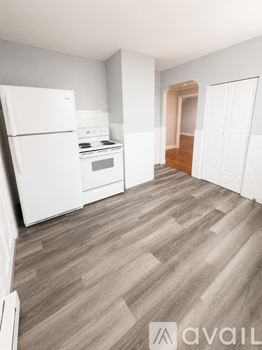A kitchen with a white fridge and a white stove top oven.