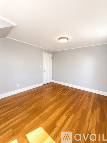 A room with wooden floors and a white door.