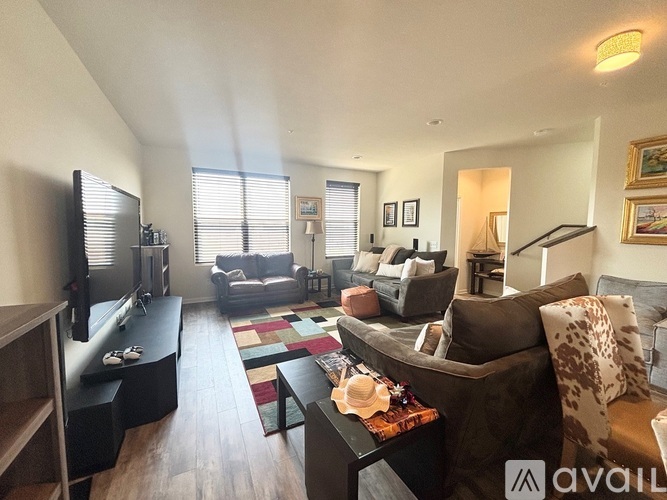 A living room with a brown couch and a television.