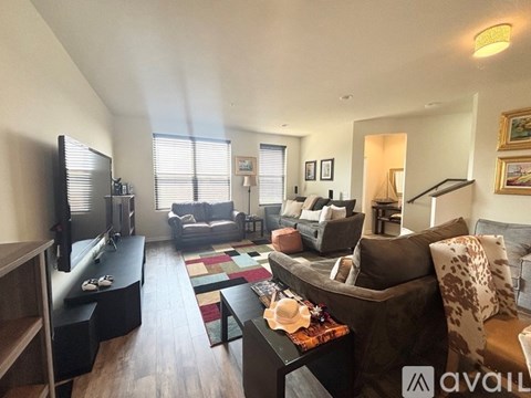 A living room with a brown couch and a television.