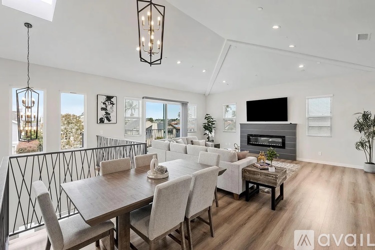 A modern dining room with a wooden table and chairs.