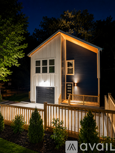A house with a lit up garage door.