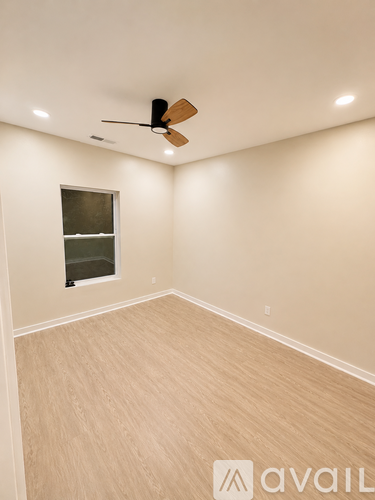A room with a ceiling fan and lighting fixtures.