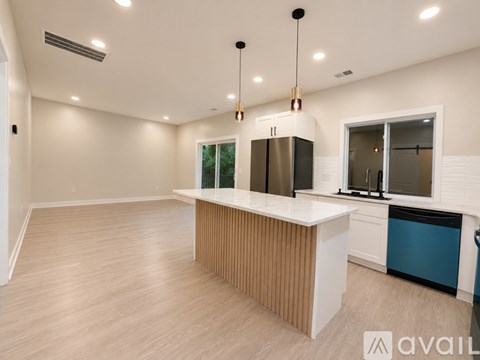A kitchen with a white counter and a refrigerator.