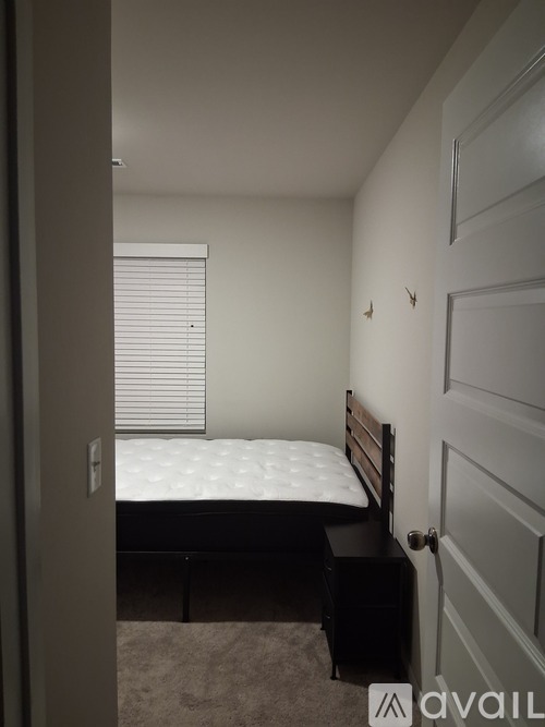 A white closet with a hanger on the rod.