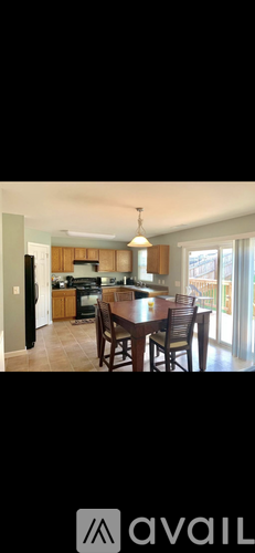 A kitchen with a dining table and chairs.