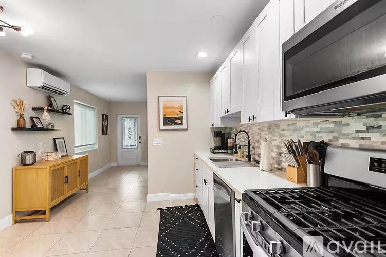 A kitchen with a stove top oven and a microwave above it.