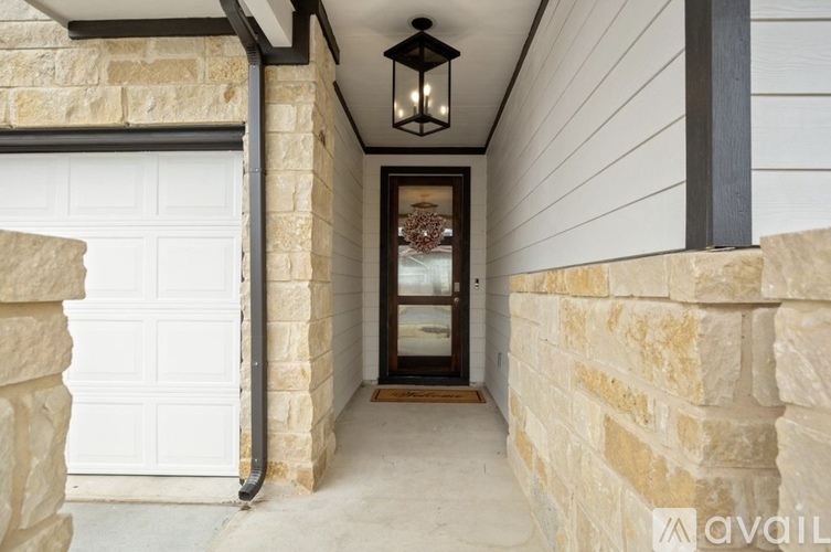 A white garage door is on the left and a black lantern hangs from the ceiling.