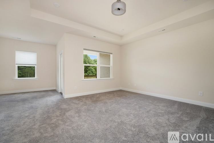 A spacious room with a window and a door is available for rent.