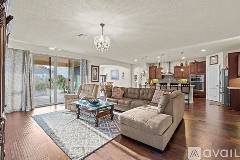 A living room with a glass table and a couch.
