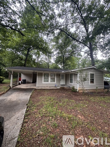 A house with a front yard and a driveway.