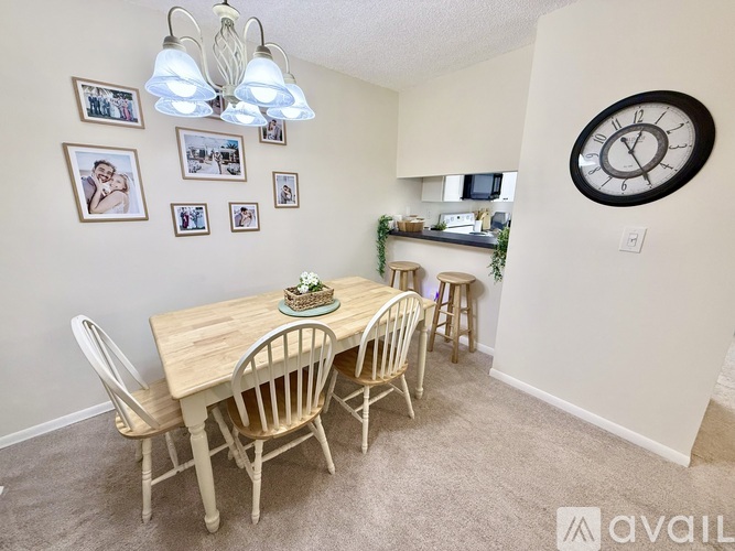 A dining room with a wooden table and chairs.