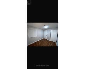 A room with wooden floors and white walls.