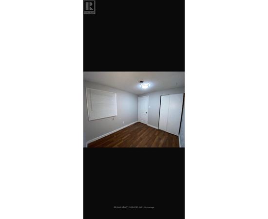 A room with wooden floors and white walls.