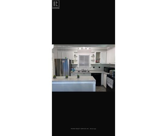 A modern kitchen with white cabinets and a large island.